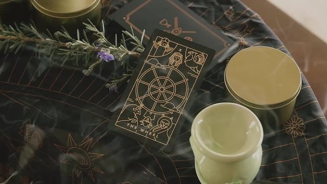 Slow zoom into tarot card amidst incense smoke