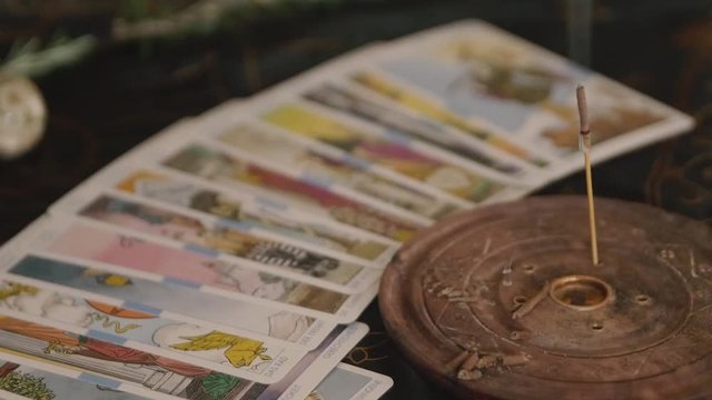 Slow zoom out altar with incense and major Arcana tarot cards