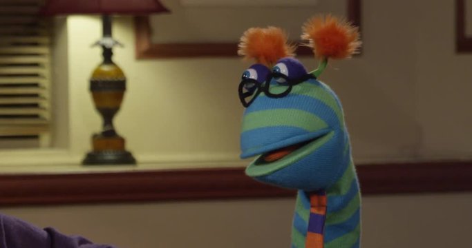 Cute Puppet Wearing Glasses and a Tie Listening and Looking Confused.