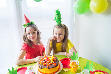 Two girls celebrate their birthday. Fruit Party. Pineapple and watermelon costume. Children's holiday.