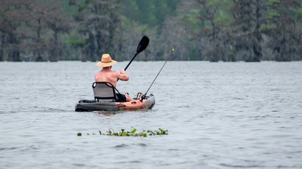 Fototapeta na wymiar People are enjoying canoing, boating and fishing in swamp