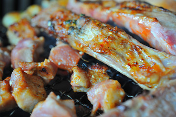 Close up shot pork grilling and bacon on grill plate. Eating Korean BBQ.