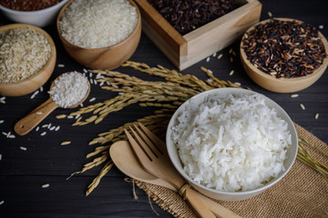 Steamed rice with organic rice and paddy rice seed on wooden table