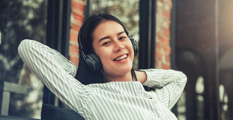 young woman happy listen to music in cafe