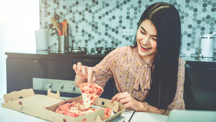  Young asian woman eating pizza