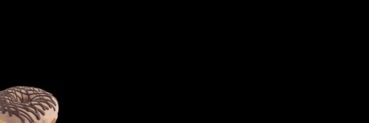 Appetizing donut in chocolate icing on a black background. Isolated. Banner.