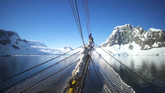Antarctica Fjord Channel View from Sailboat sailors on bow