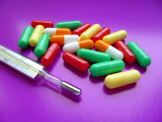 colorful pills on purple background