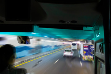 Urban roads through the front window of the bus as abstraction. Motion blur.