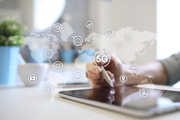 5G networks and telecommunication concept on virtual screen with world map and icons.