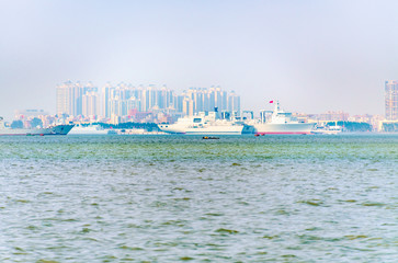 Fototapeta premium The wheels and ships of the docks on the other side of Zhanjiang Seaside Park