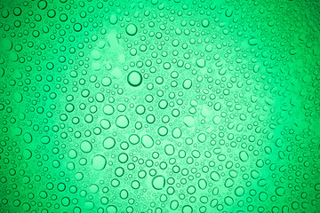 Rain droplets on green glass background, Water drops on glass.