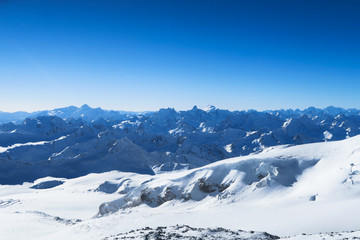 Mountain ranger of Caucasian Mountains in the blue sky. Elbrus region