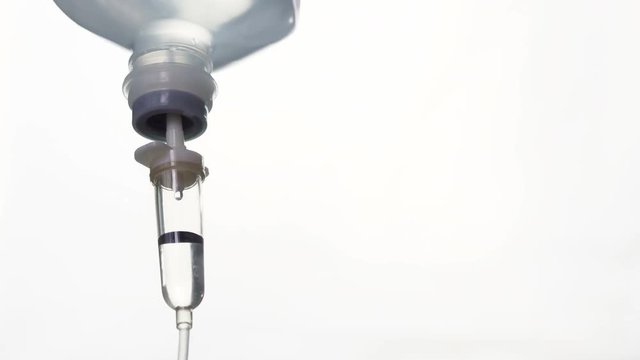 Intravenous drip chamber on white background