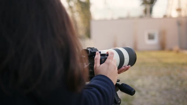 girl photographer shoots with telephoto lense