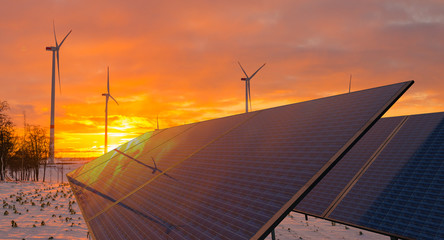 solar panels and wind turbines working in winter