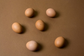 Fototapeta na wymiar brown eggs pattern on a brown background