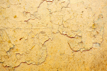 Peeling beige  paint on the wall