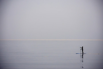 Tourists on surf boards in the sea at Prachuap Bay in Thailand.
