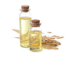 rice paddy with rice bran oil in glass bottle on white background