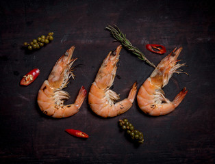 Grilled shrimp,prawn BBQ style with spices and chilli on wood background,top view