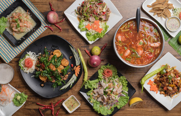 Set of thai food on table, Steak, Fish, Vegetables and Spices on a wooden 