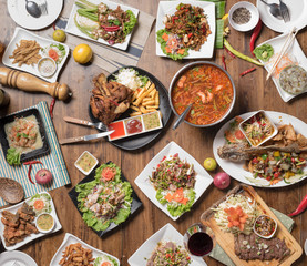 Set of thai food on table, Steak, Fish, Vegetables and Spices on a wooden