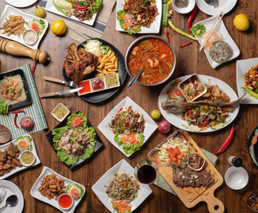 Set of thai food on table, Steak, Fish, Vegetables and Spices on a wooden
