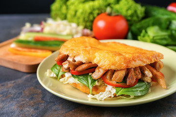 Plate with tasty doner kebab on table