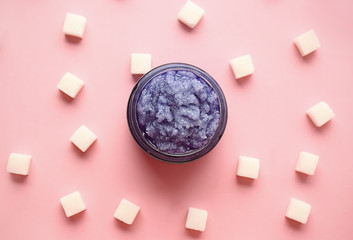 Jar of sugar scrub on color background