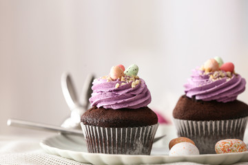 Tasty Easter cupcakes on plate