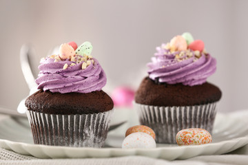 Tasty Easter cupcakes on plate