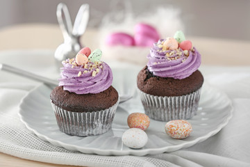 Tasty Easter cupcakes on plate
