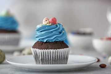 Tasty Easter cupcake on plate