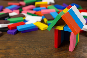 The domino multi color build home on wood table image.