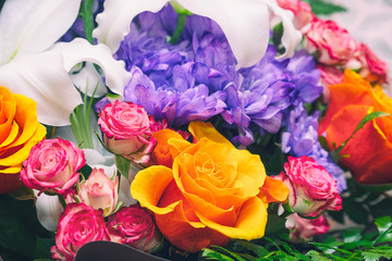 Blue chrysanthemums, orange and pink roses in a beautiful bouquet