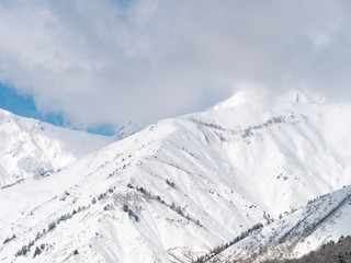 Fototapeta na wymiar 雪山と雲と空の風景イメージ素材