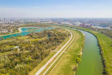 Zagreb, Croatia, Jarun lake, beautiful green recreation park area, sunny spring day, panoramic view from drone, city in background