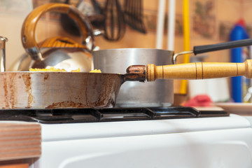 Pan on the gas stove close-up. Kitchen utensils