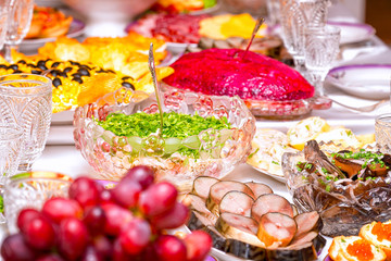 Snacks, fruits, sandwiches, salads, caviar and slicing on the holiday table