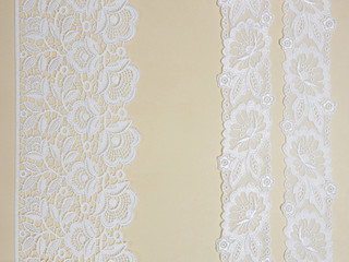 White lace on a beige background