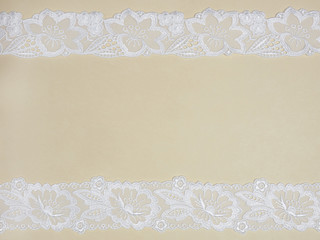 White lace on a beige background