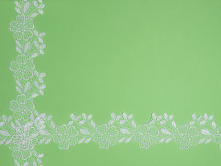 White lace on a green background