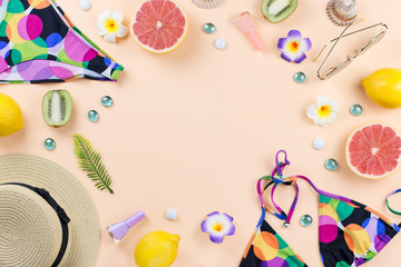 Bikini swimsuit with straw hat, flowers and fruits, flat design, summer concept. Beach destination, summer fashion
