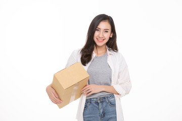 Fototapeta na wymiar Delivery, relocation and unpacking. Smiling young woman holding cardboard box isolated on white background
