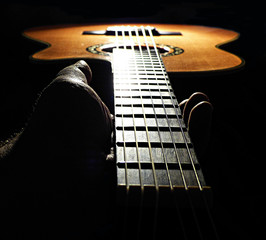 Hand holding neck of the guitar