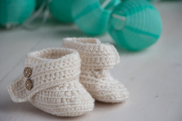 Fototapeta na wymiar Newborn baby booties, beige, cozy and nice. Child clothe and boots - knitted and sweet. Text space, copy past and place for your design