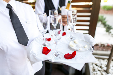 Waiter holding tray with champagne glasses
