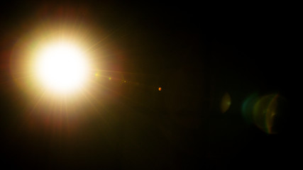 Flash of a distant abstract star. Abstract sun flare. The lens flare is subject to digital correction.