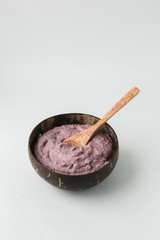 Healthy smoothie bowl , handmade plate made from coconut shell and wood spoon